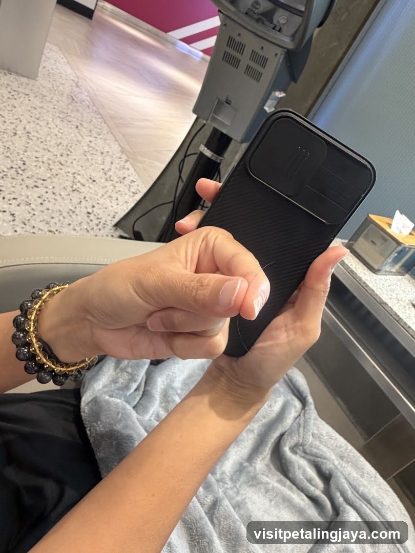 Person holding phone in salon or spa setting