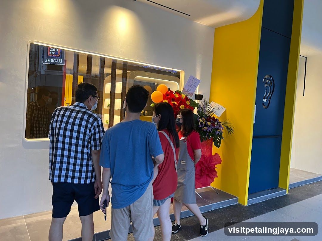 Group at Shop Entrance with Balloons and Flowers