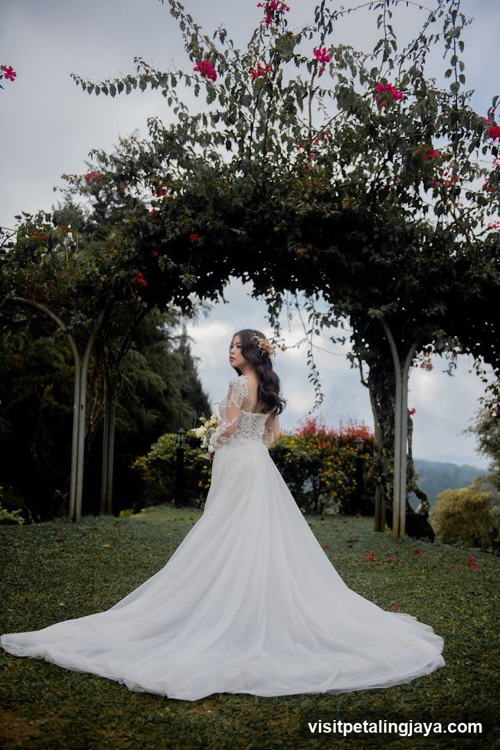 Bride in White Gown Under Flower Arch