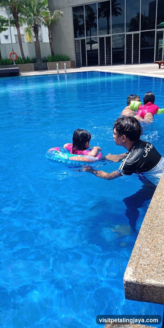 Poolside Scene with Children Learning to Swim