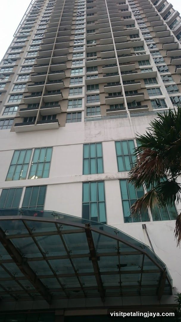 High-rise building exterior with glass canopy