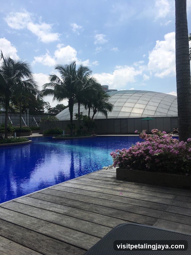 Poolside View with Palm Trees and Flowering Bushes