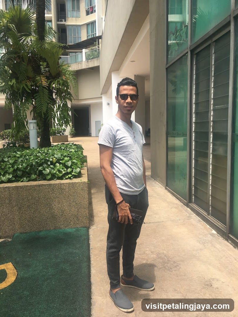 Man Standing Outside Building Entrance