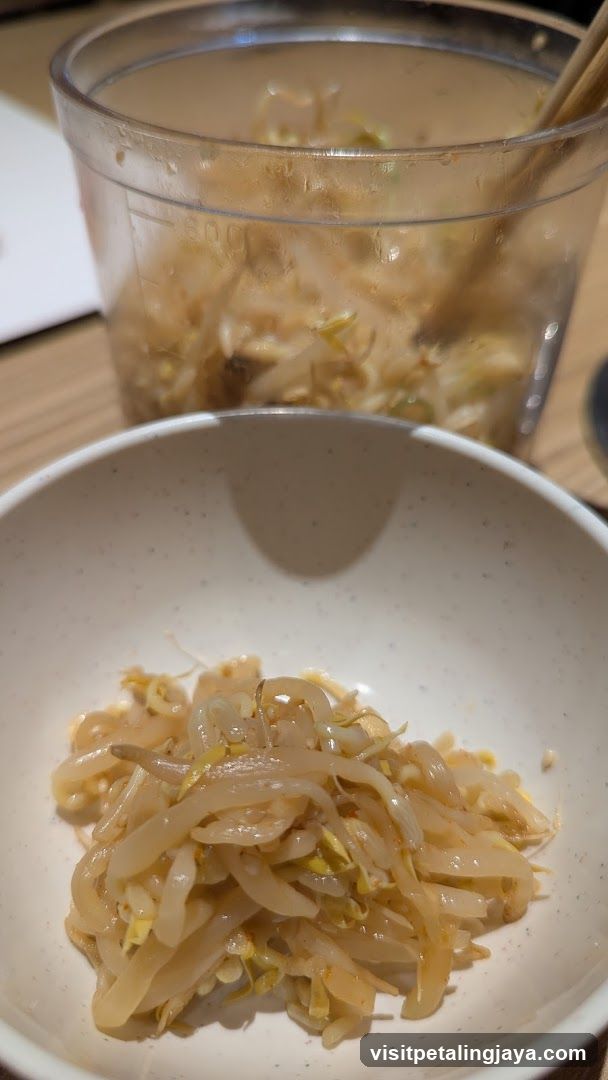 Bowl of pickled vegetables with a glass jar in the background