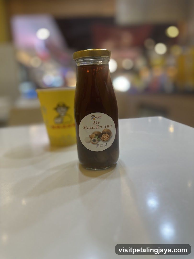 Bottle of Air Mata Kucing on a table
