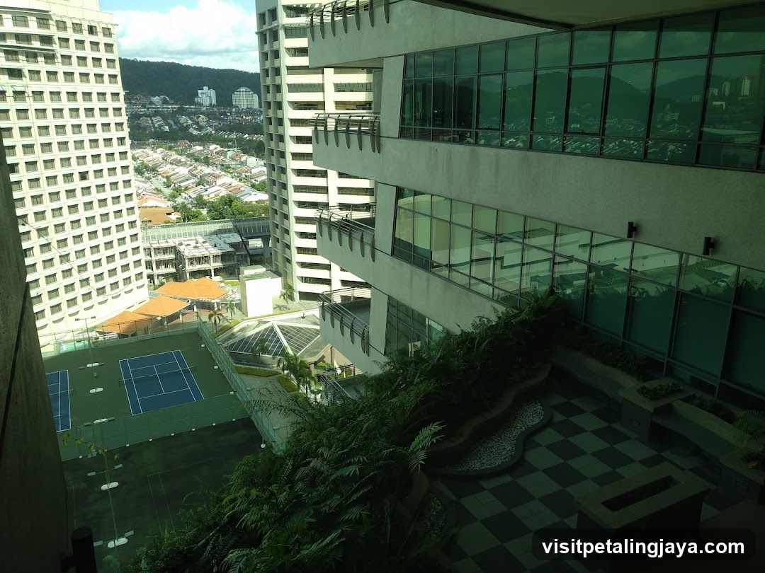 High-rise building exterior with tennis court and city view