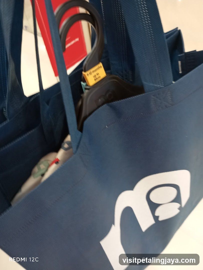 Blue tote bag with logo and hanging item