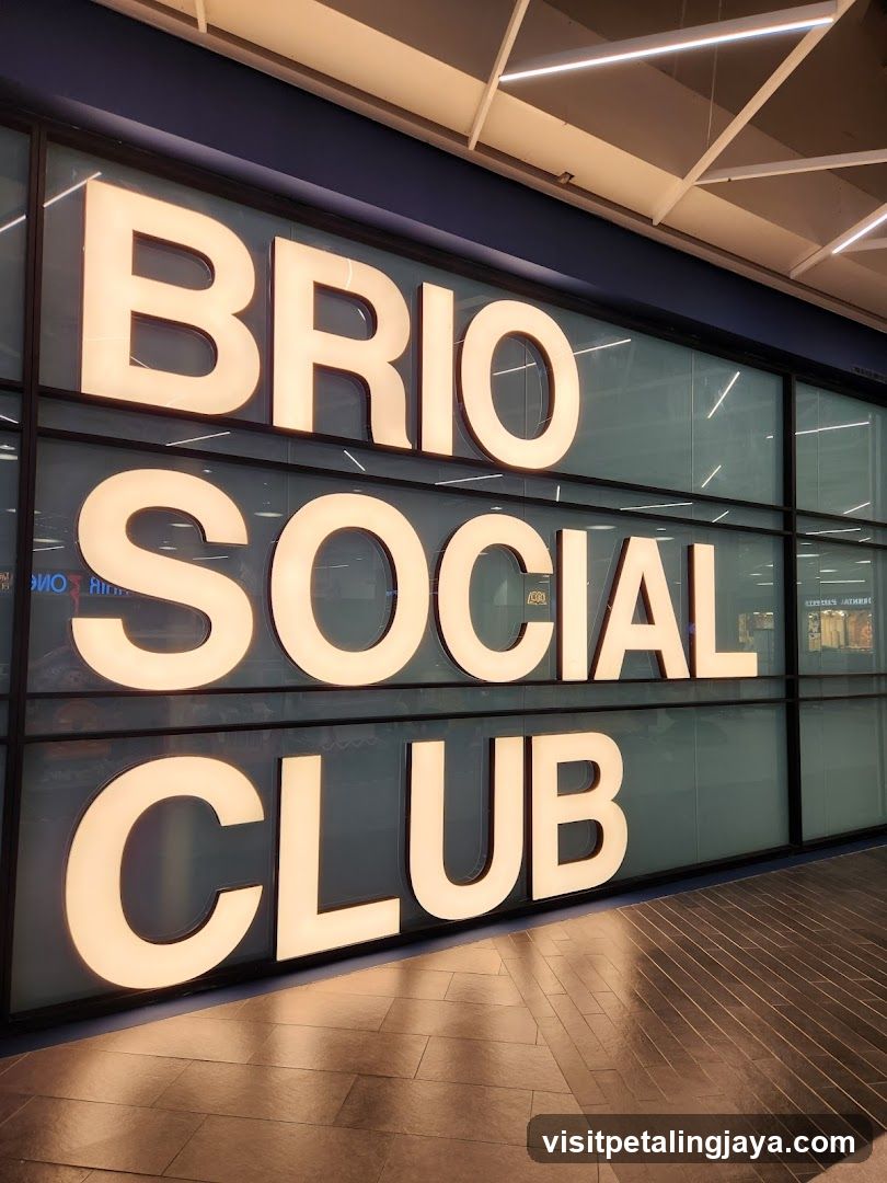 A modern storefront featuring large, illuminated lettering spelling 'BRIO SOCIAL CLUB' on a glass facade with dark framing. The sign is mounted on the building exterior, visible from outside.