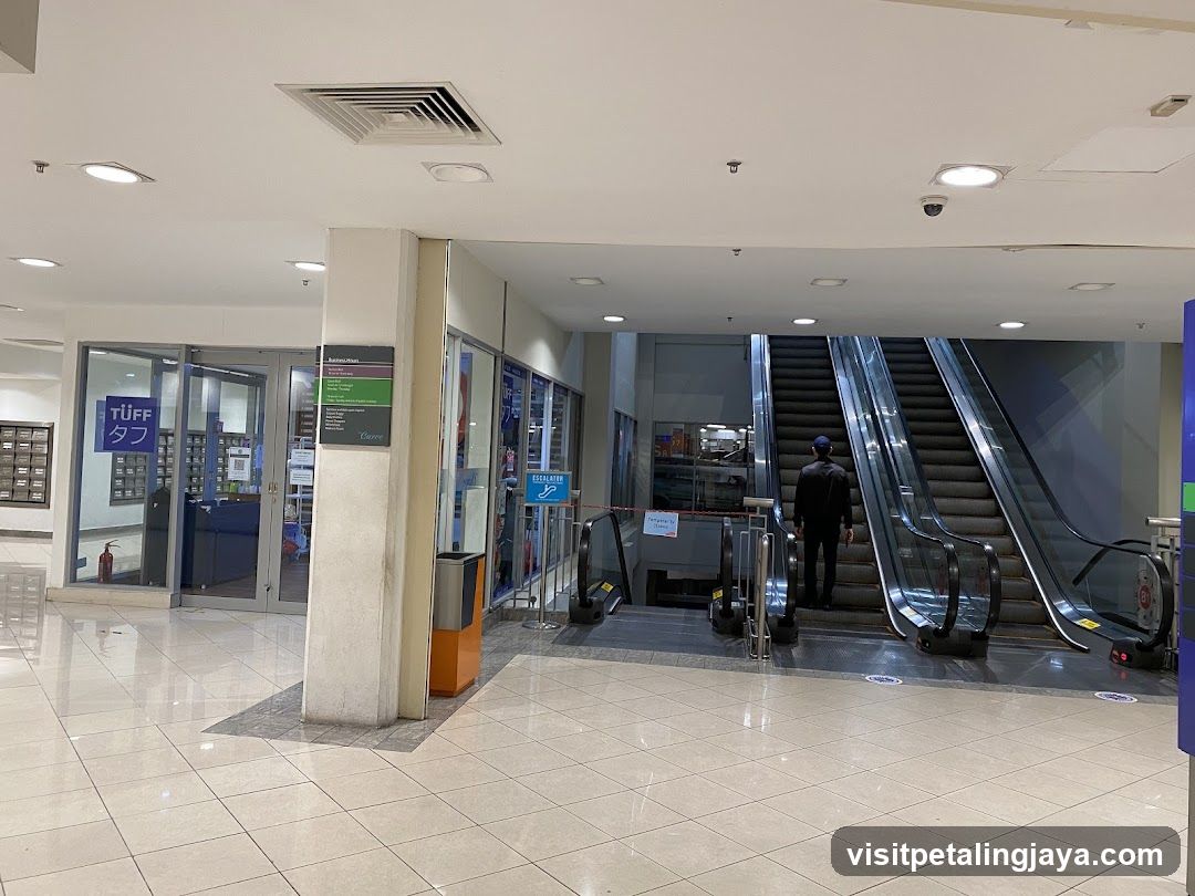 Mall Interior with Escalators and Storefronts
