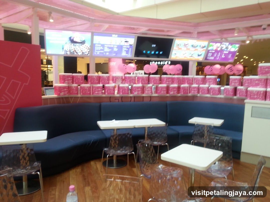 Pink-themed food court seating area