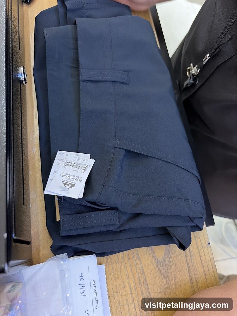 Folded dark blue trousers with tags