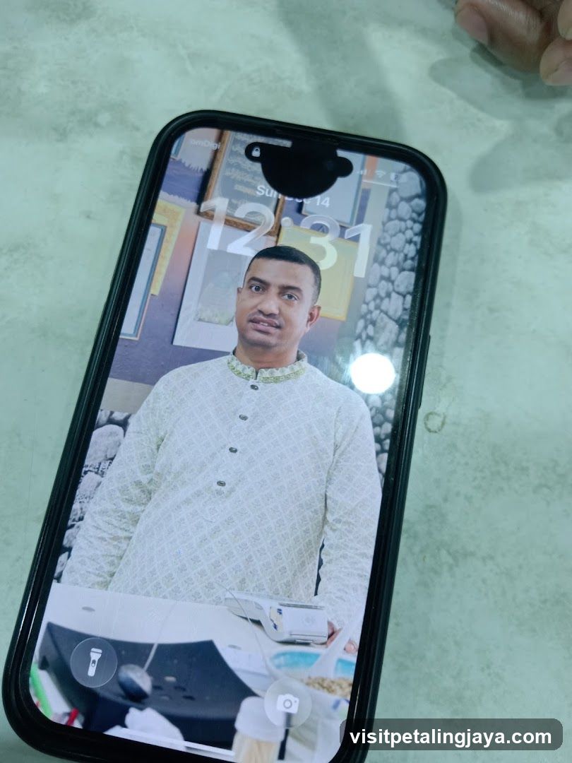 Phone Screen Displaying Portrait of a Man in Traditional Attire