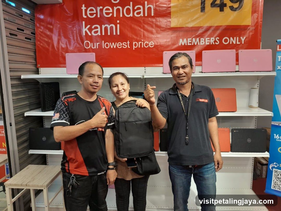 Laptop Store Interior with Staff and Product Display