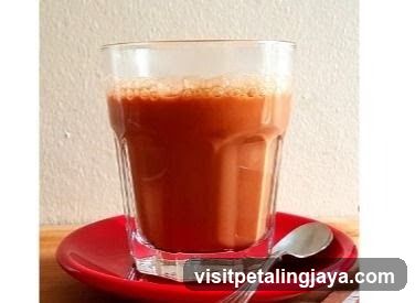 Glass of Red Drink on Saucer