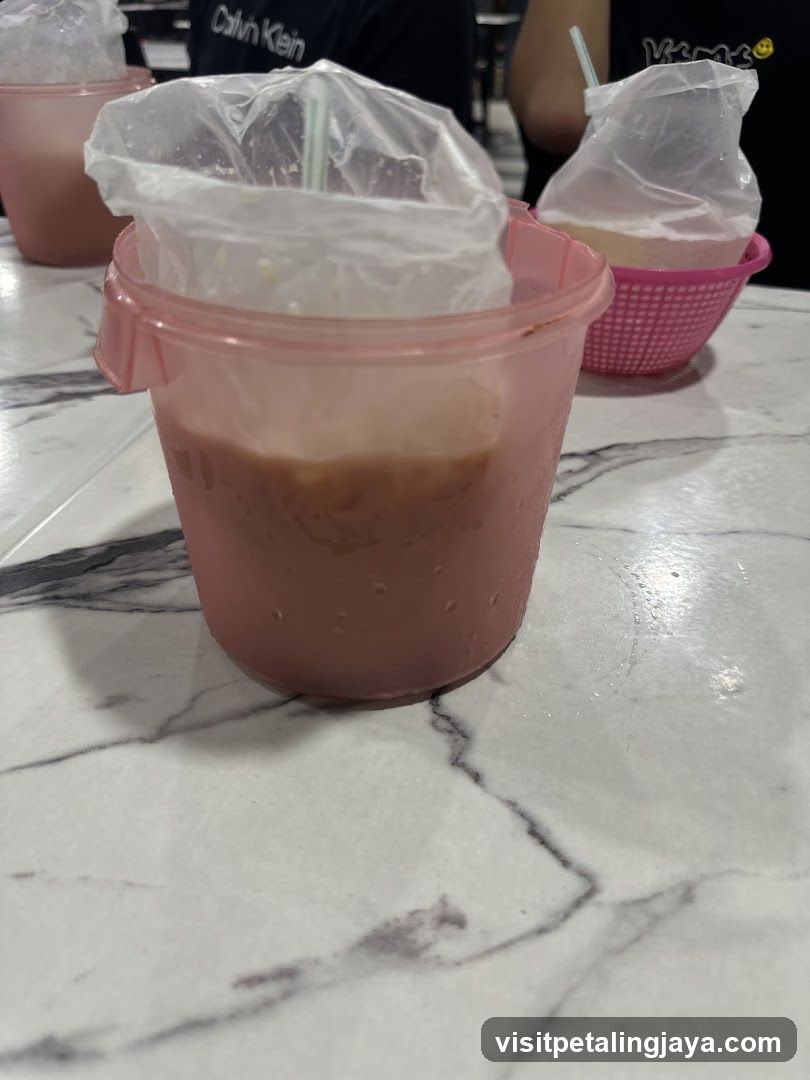 Beverages in plastic cups on table