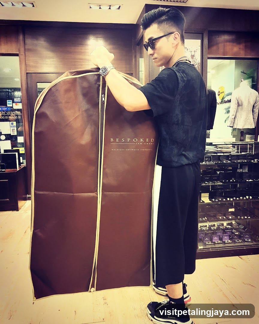 Man holding garment bag in store