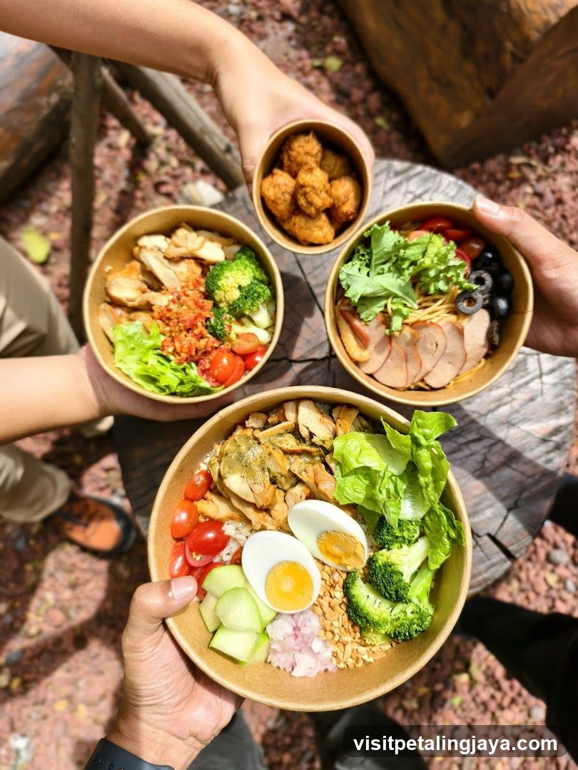Group of people holding bowls of food outdoors