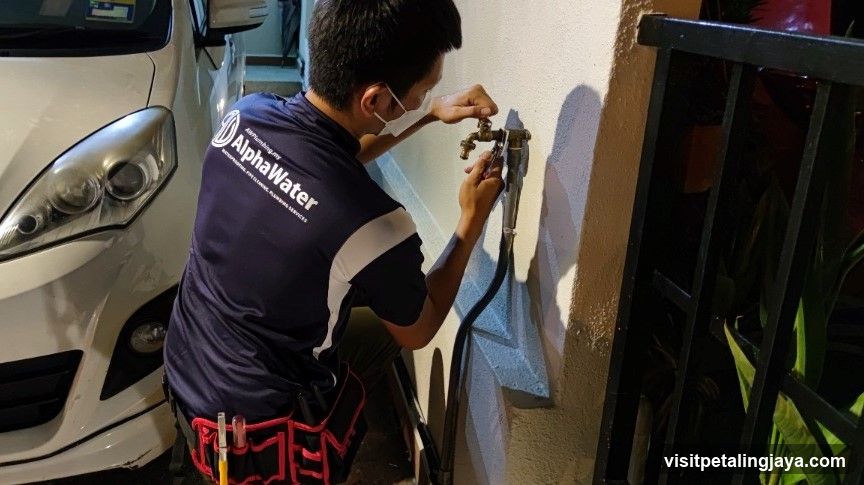 Plumber fixing water tap