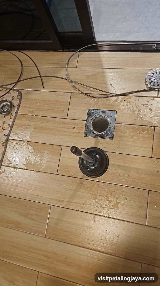Floor with Plumbing Tools and Drain Cover