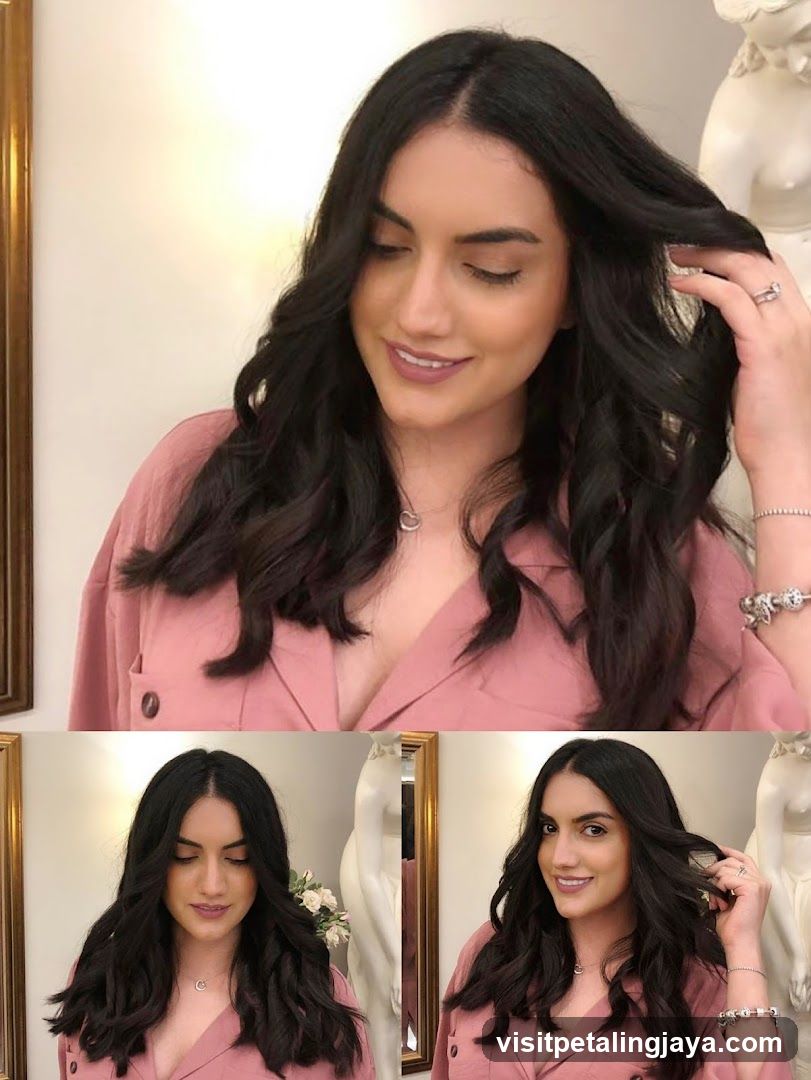 Woman with wavy dark hair in pink blazer