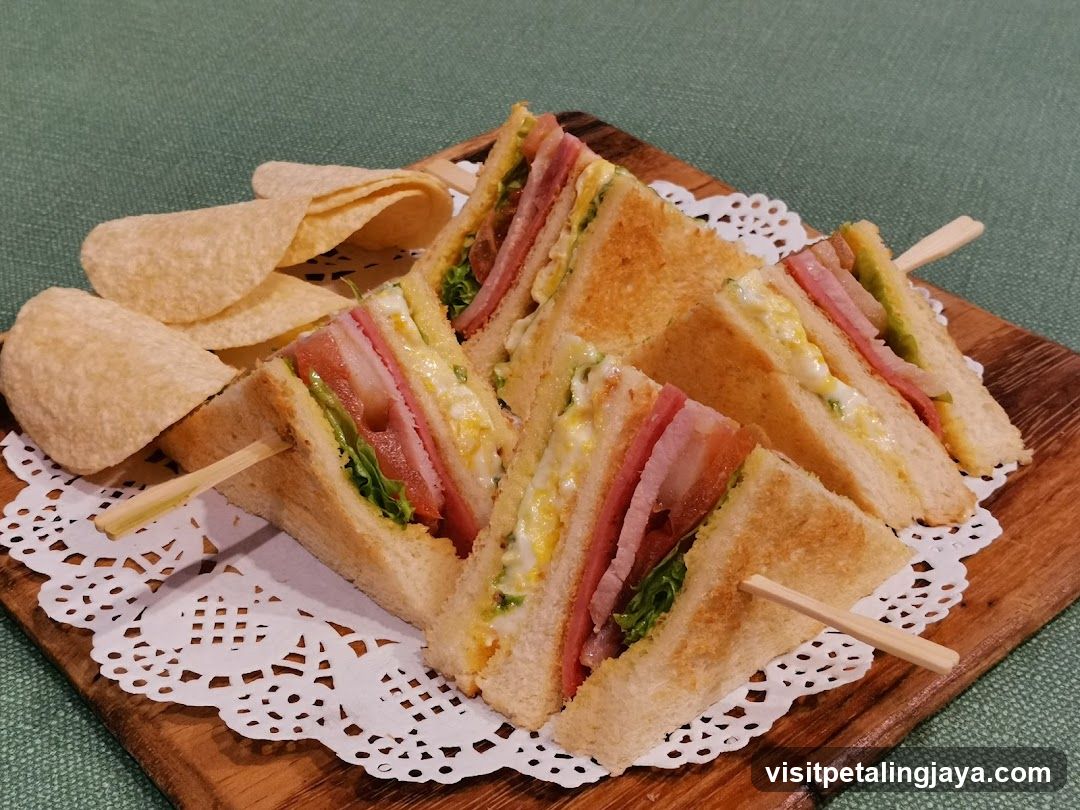 Sandwiches and chips on wooden board