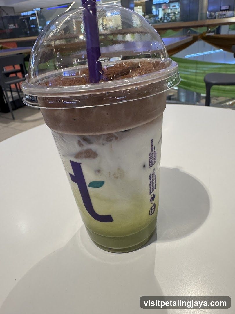 Iced beverage in plastic cup with dome lid and purple straw