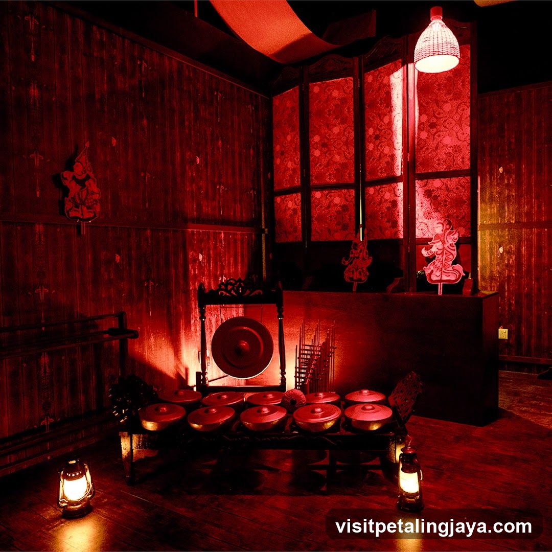 Red-lit interior with traditional instruments