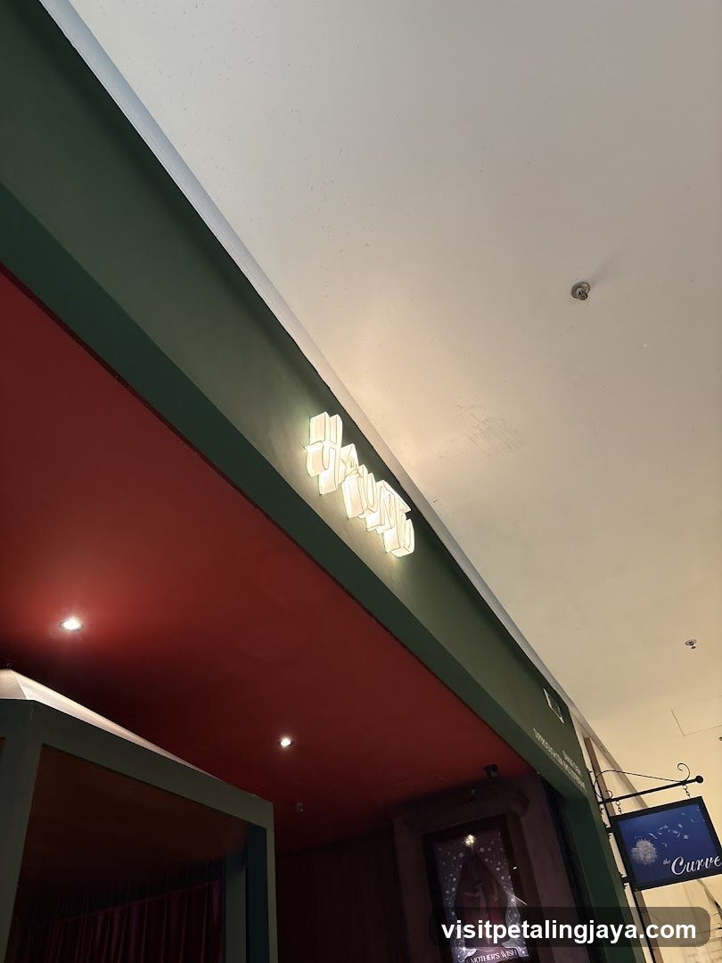 Storefront with illuminated signage and hanging sign