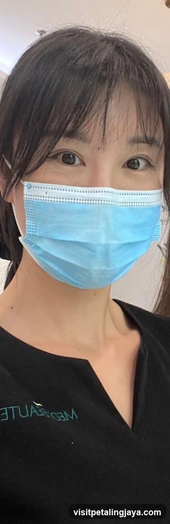 Person wearing a blue mask and black shirt with 'MED' visible on the chest.