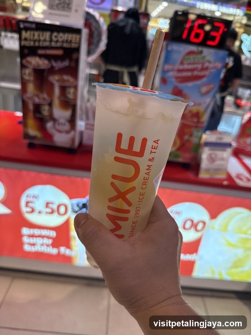 Hand holding drink at Mixue store