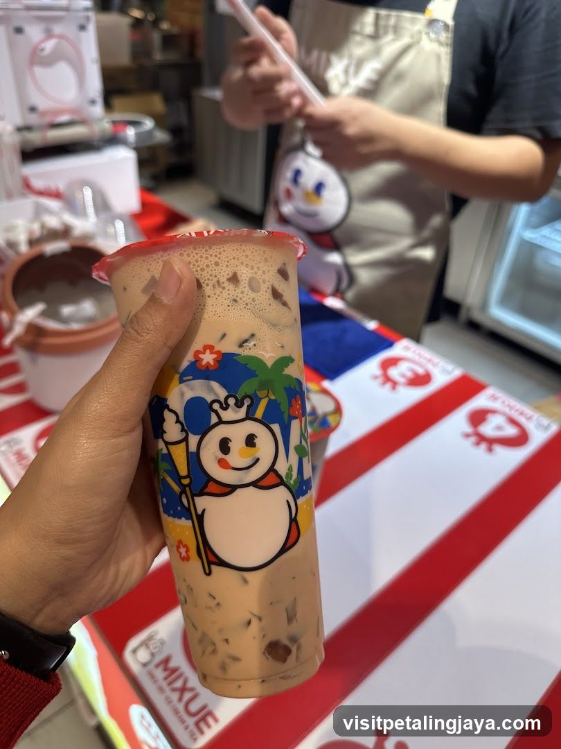 Hand holding a beverage cup at a shop