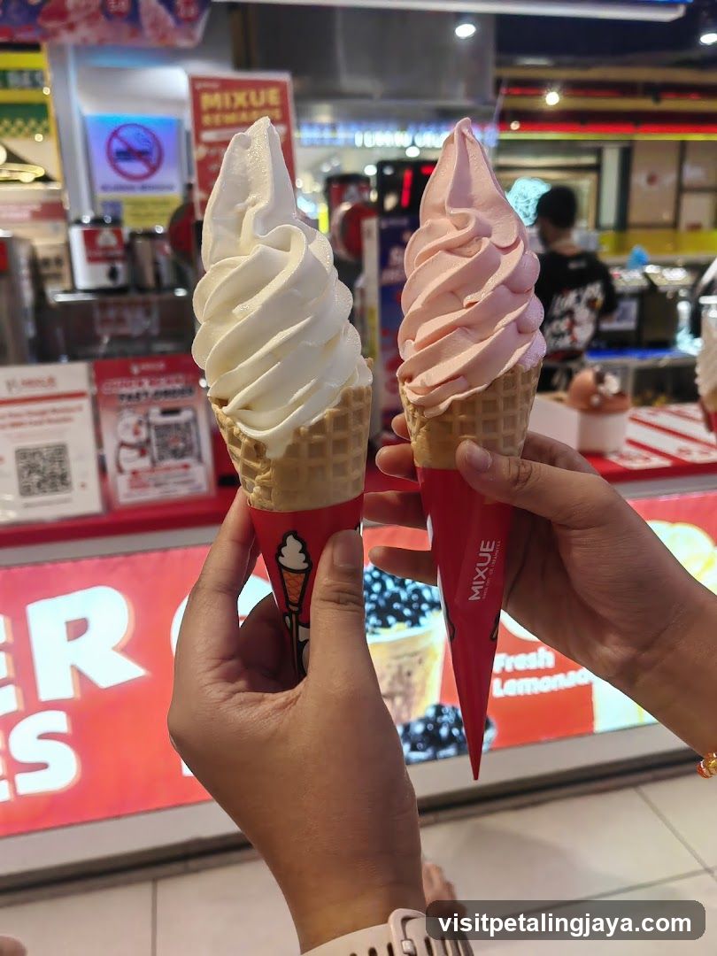 Two soft serve ice creams held in hands