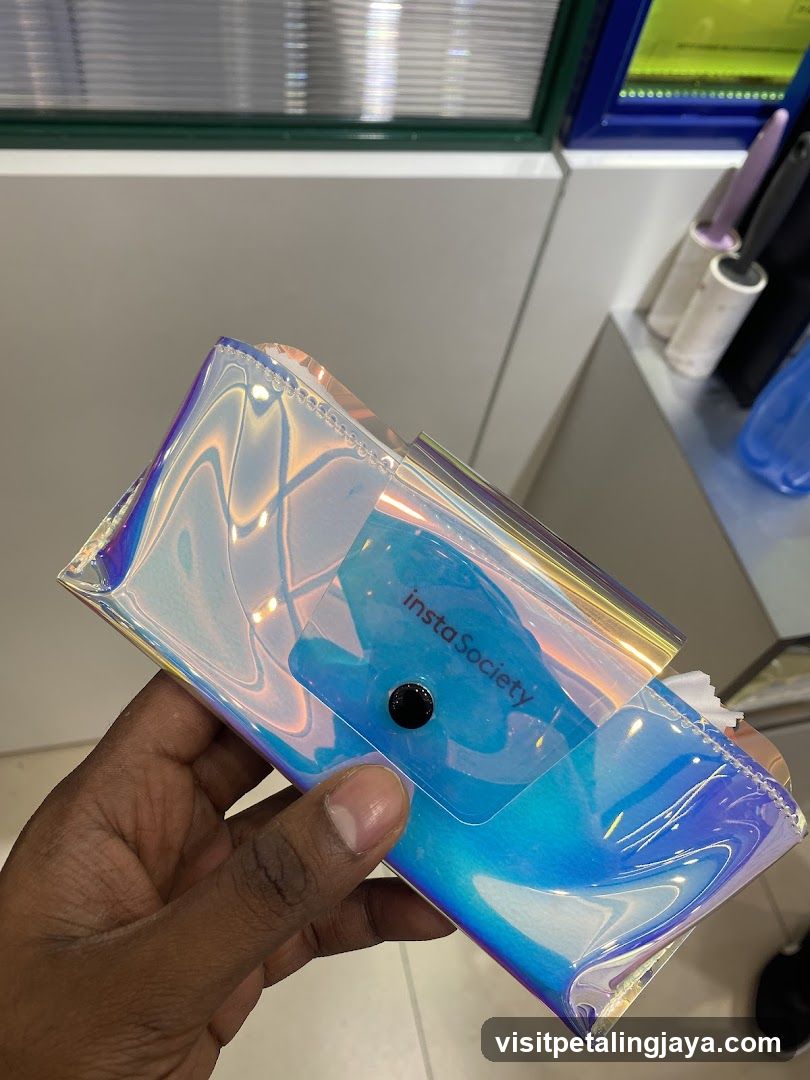 Hand holding iridescent pouch