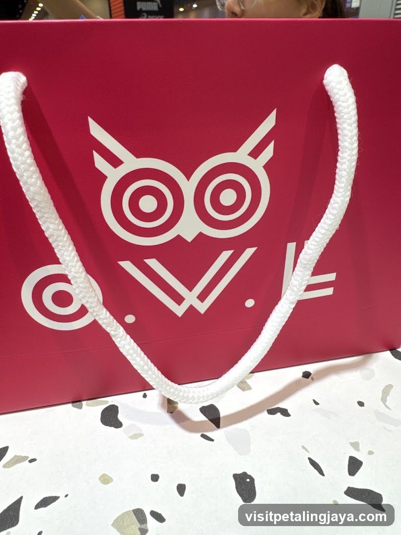 Red shopping bag with owl logo