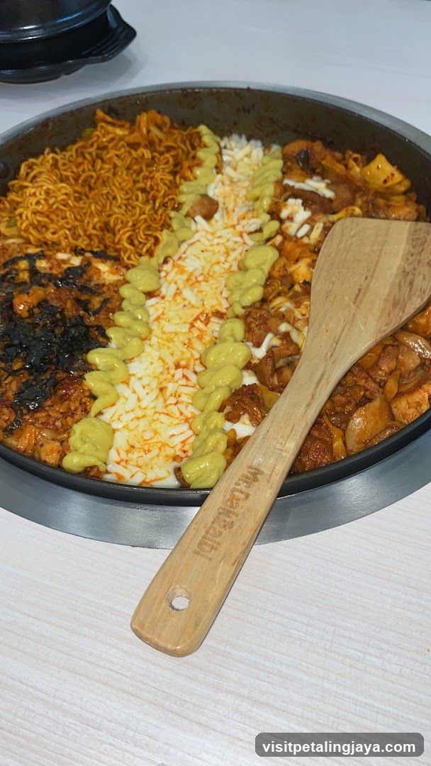 Food dish in pan with wooden spoon