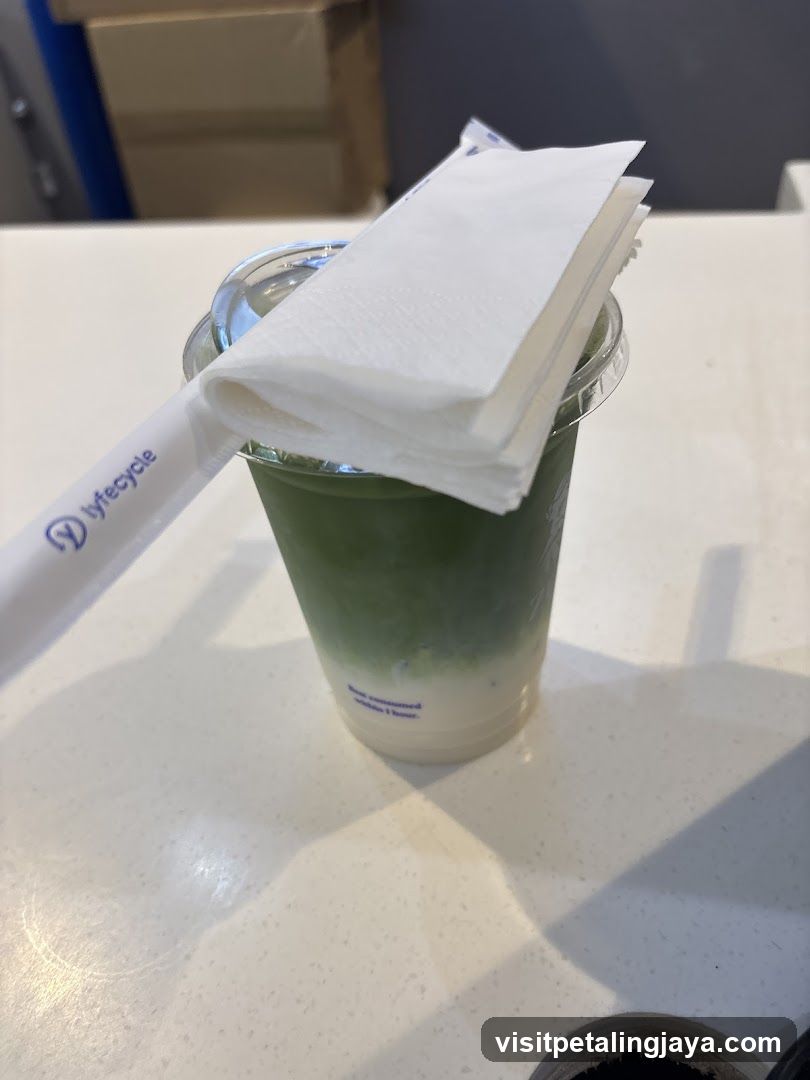 Matcha beverage with straw and napkin