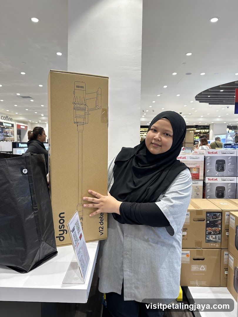Customer with Dyson product box in store