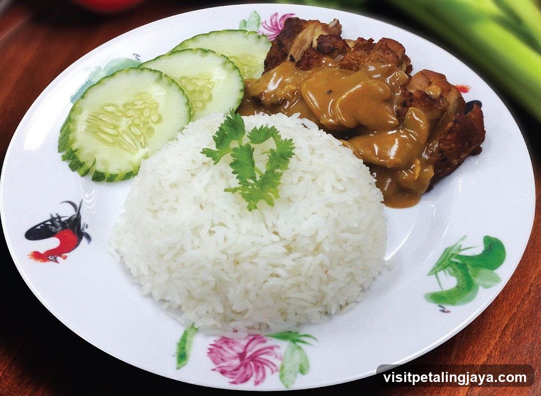 Plate of Fried Chicken with Rice and Cucumber Slices