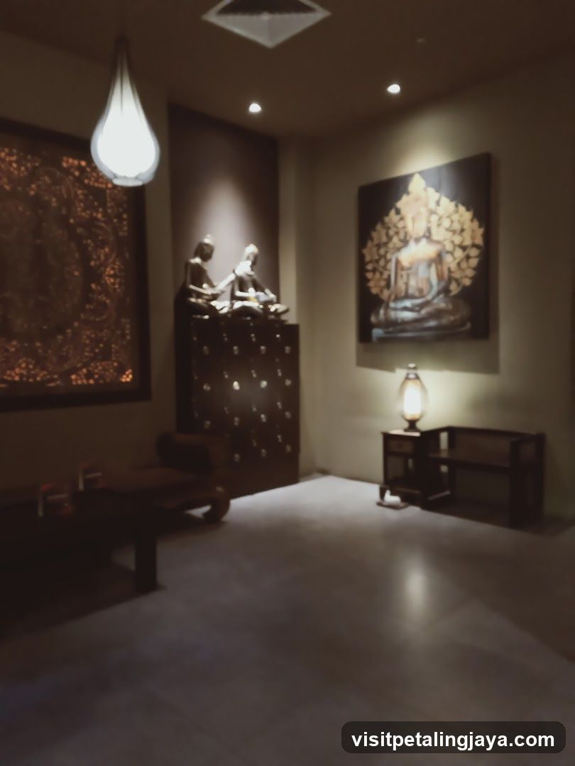 Interior of a dimly lit room with religious artwork and sculptures