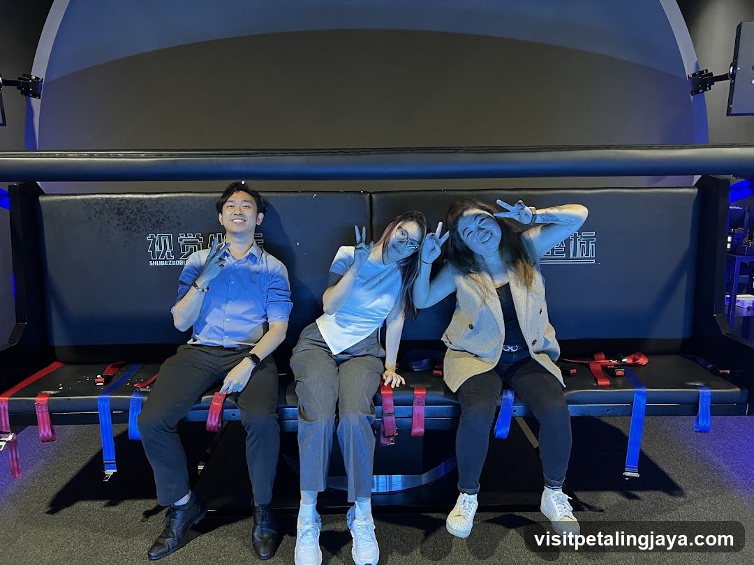 Three people posing in a VR cinema seat