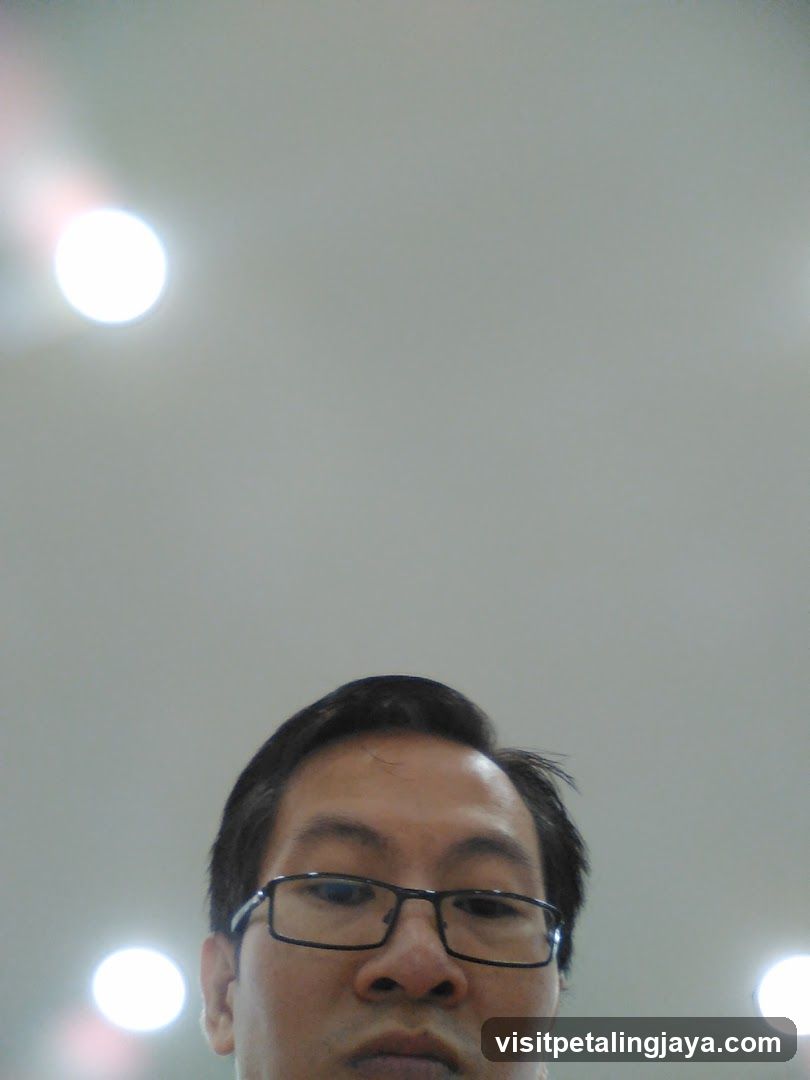 Low-angle selfie of a man with glasses