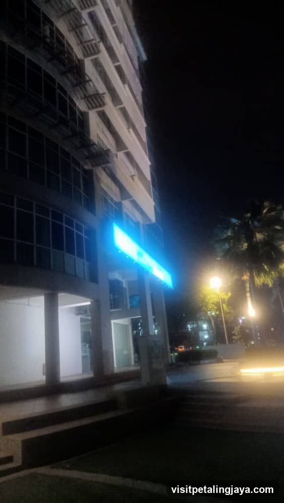 Night view of building exterior with illuminated sign