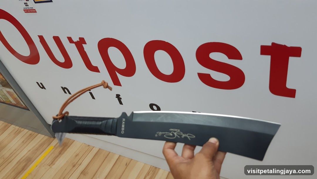 Knife held in front of storefront