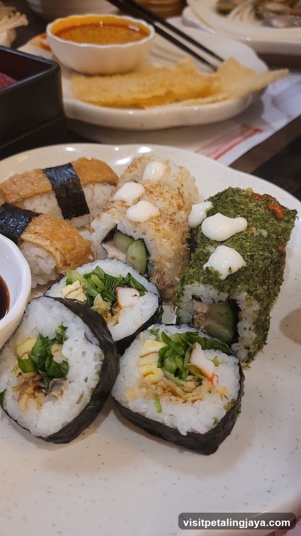 Sushi Platter with Various Rolls and Dipping Sauce