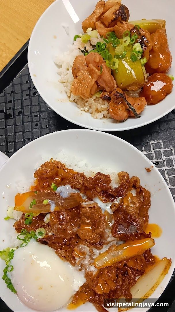 Two bowls of rice with toppings
