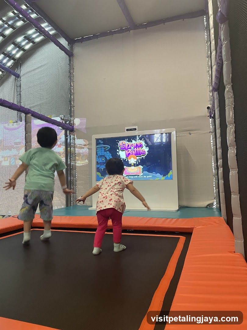 Kids Playing on Trampoline with Screen Game