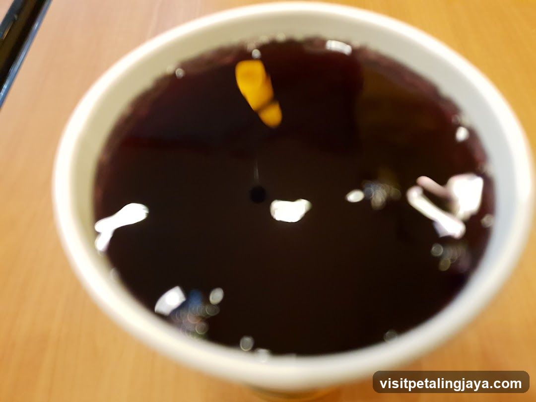 Bowl of Dark Liquid with Floating Elements