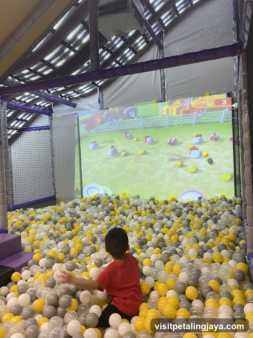 Child in Ball Pit with Screen Game