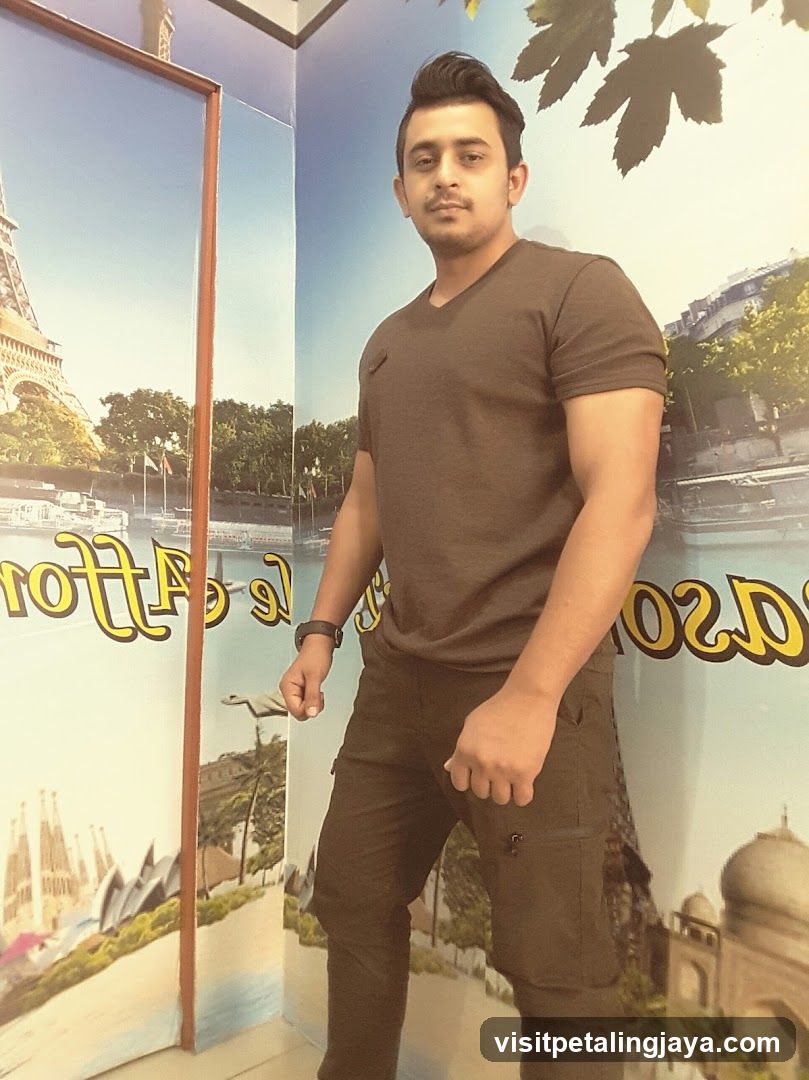 Man posing in front of travel poster display