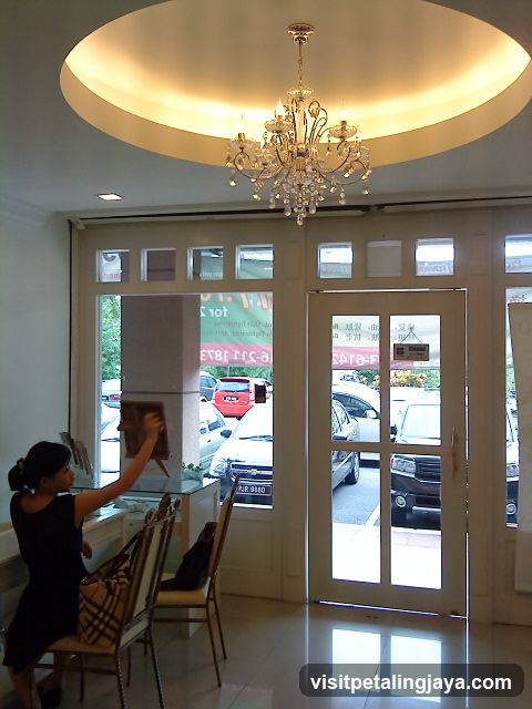Interior of a shop with staff arranging items